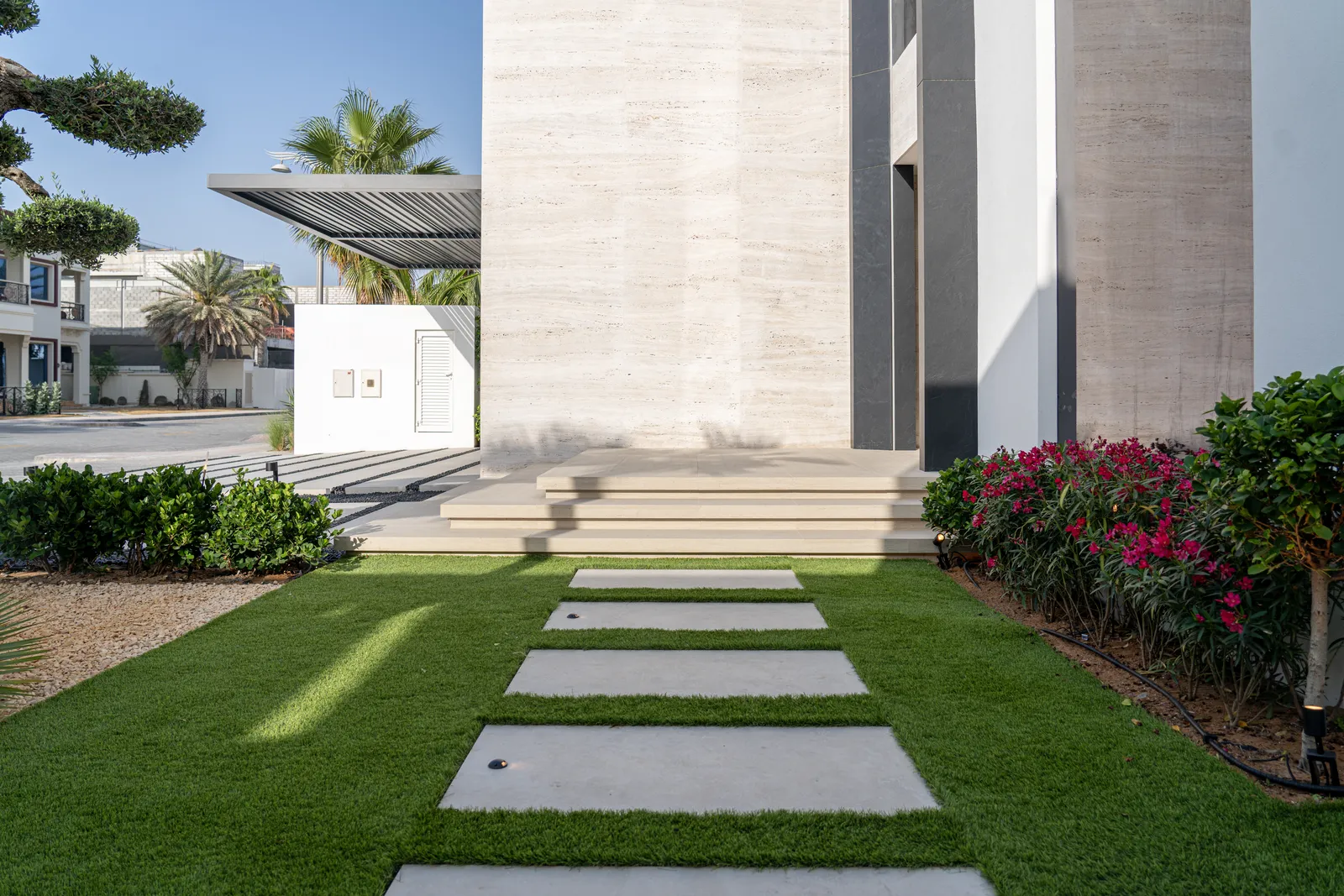 Entrance walkway with stepping stones and manicured lawn
