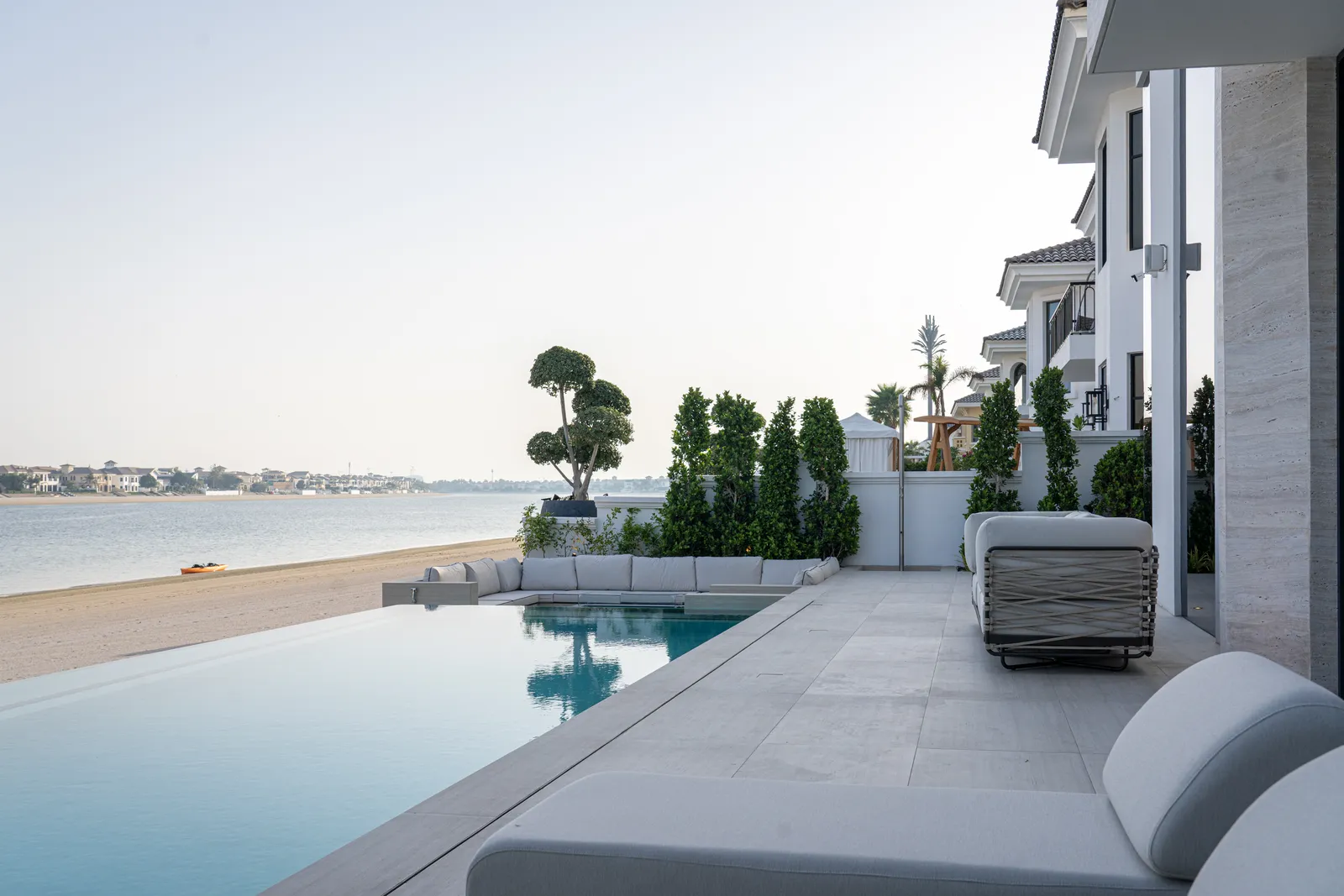 Infinity edge meeting the water with the coastline behind