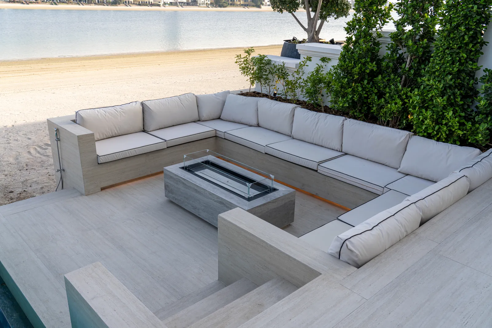 Built-in corner seating around a stone fire table