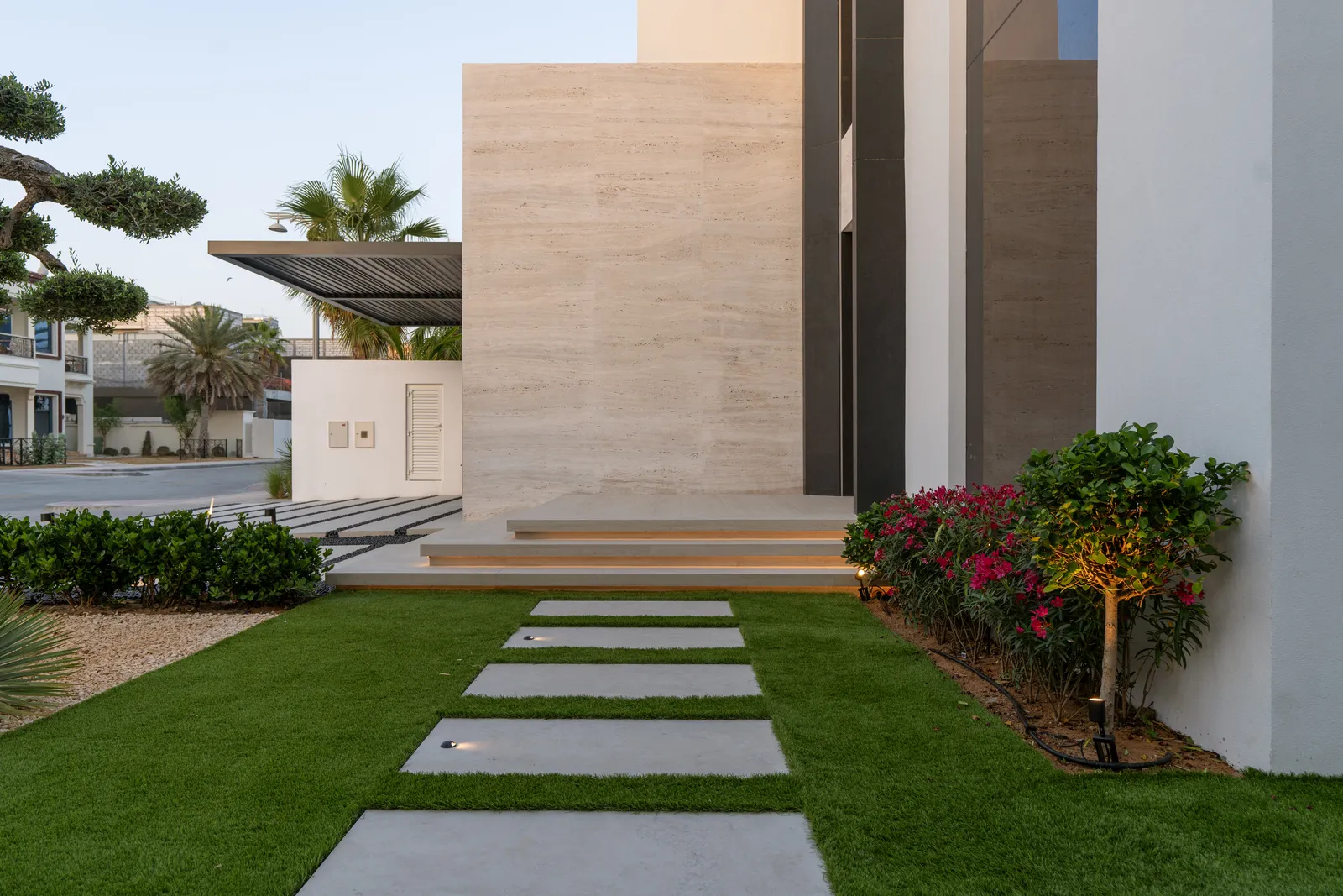Stone path leading to the front door through planted beds