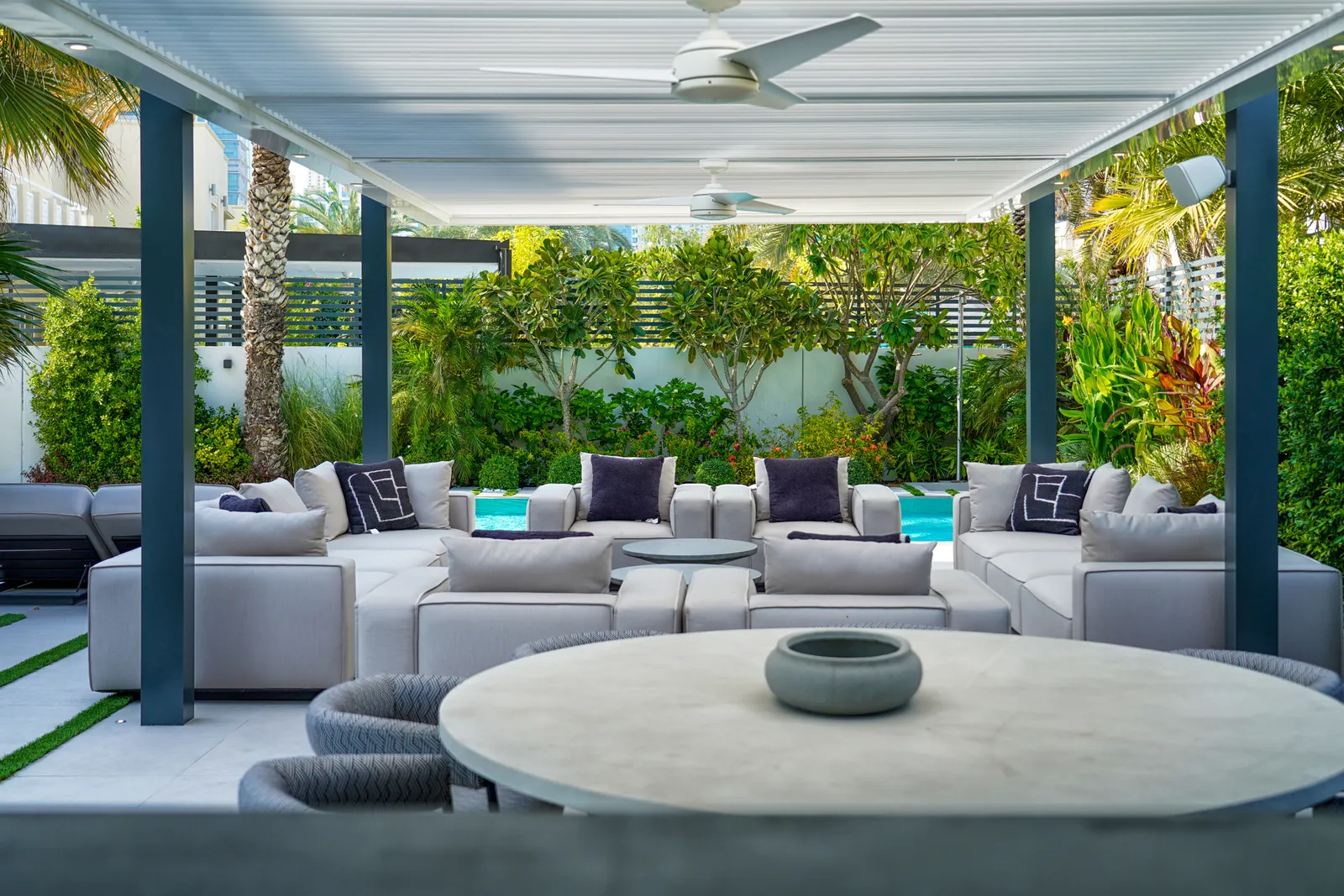 Sunken lounge and low table beneath the pergola