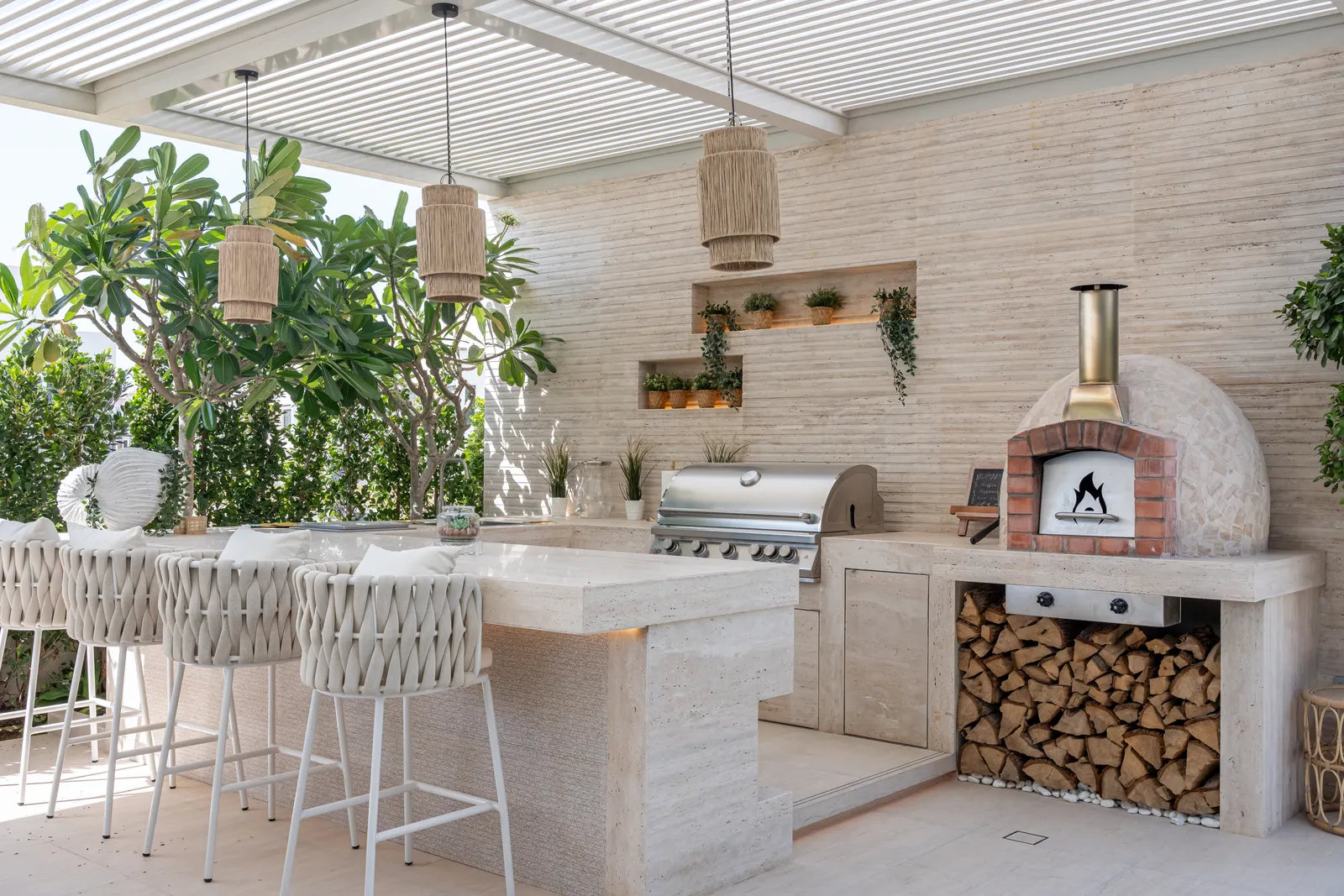 Outdoor kitchen with wood-fired oven and bar seating