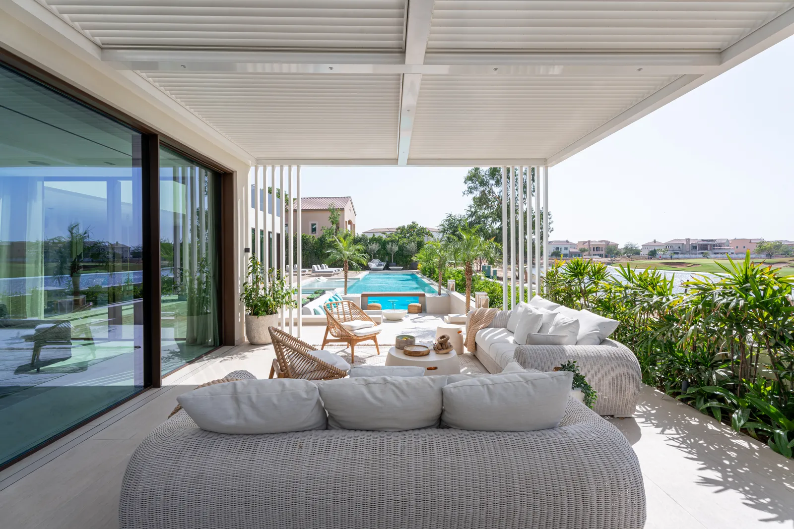 Round daybeds under the terrace canopy overlooking the pool