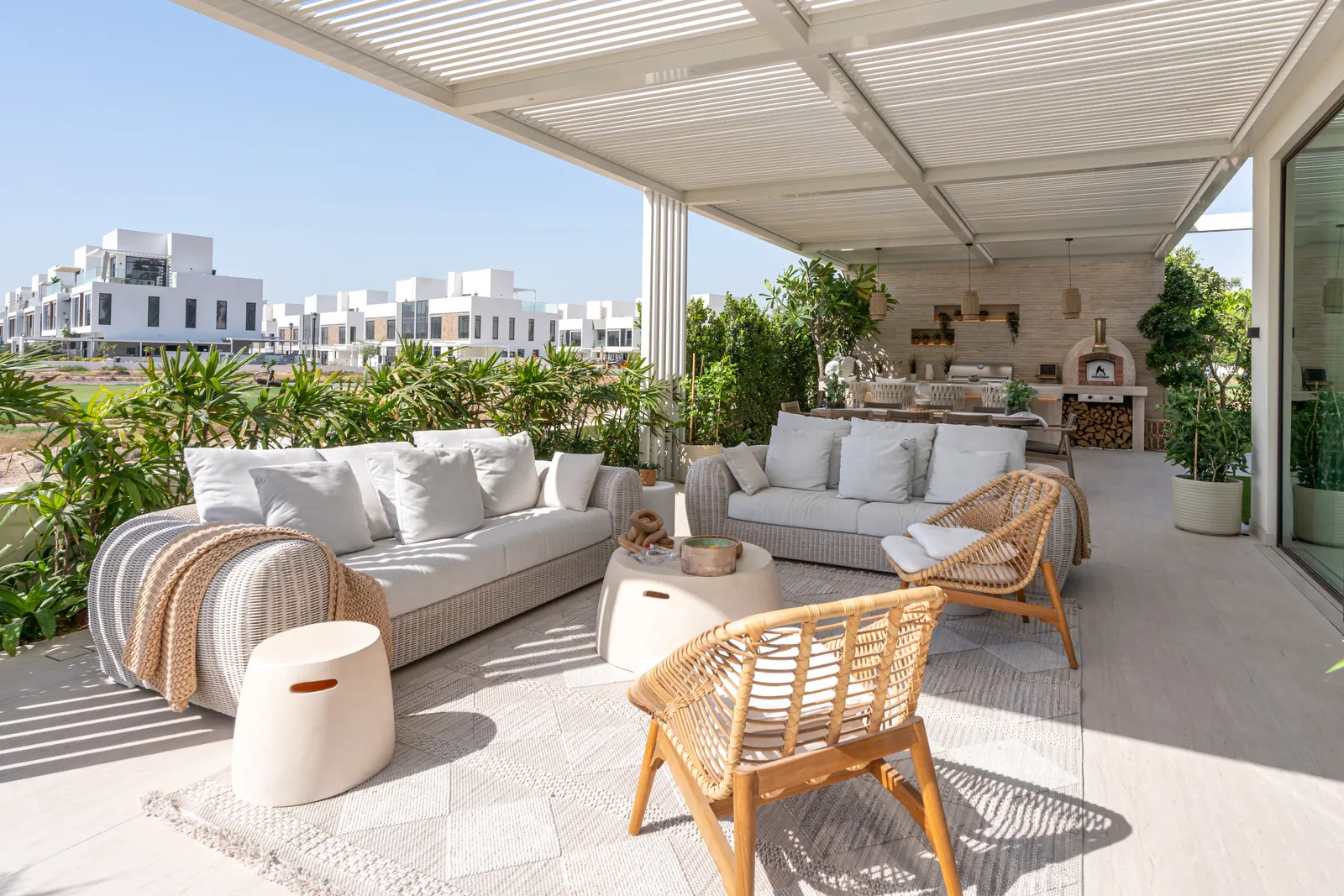 Shaded lounge with hanging chair against the villa