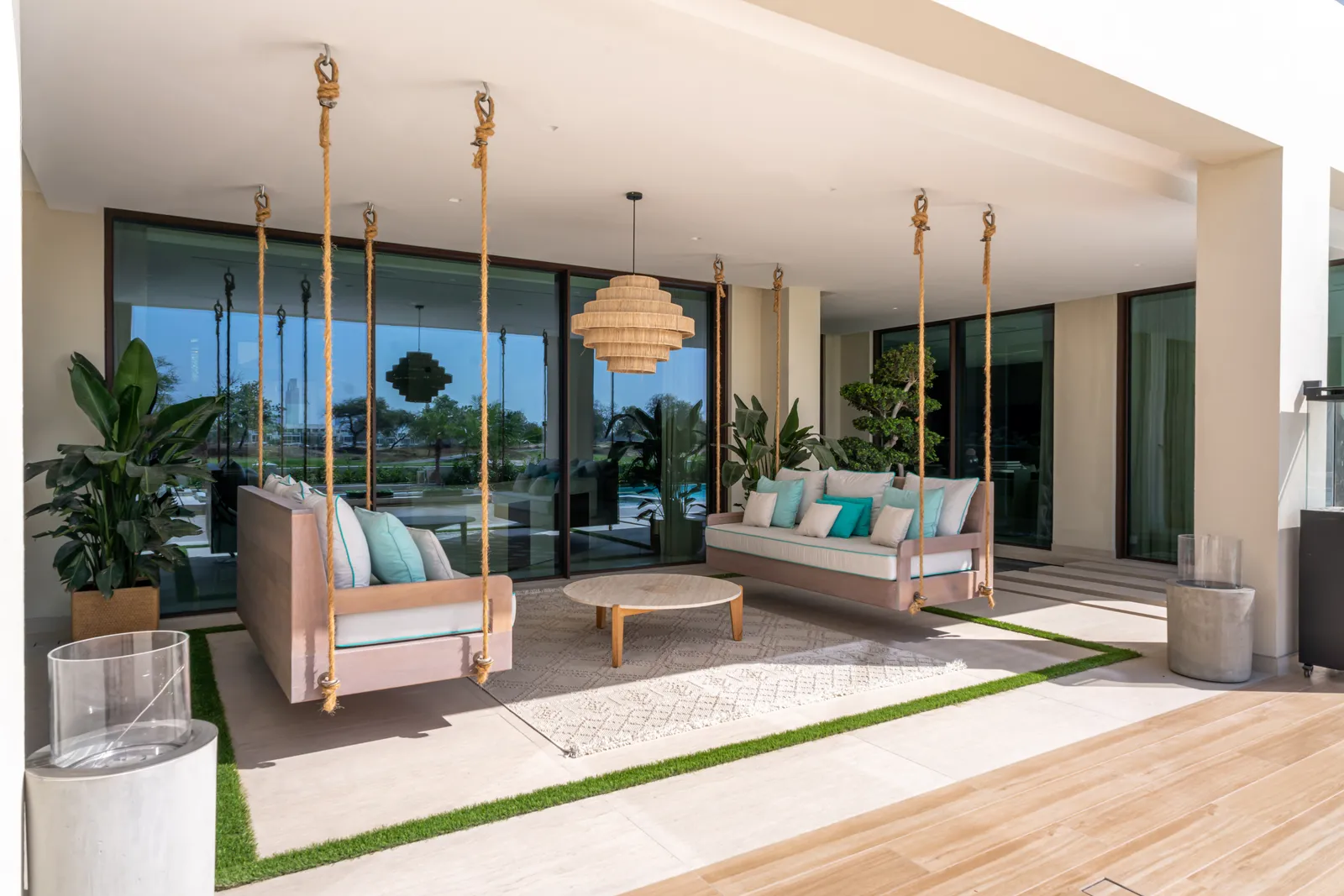 Hanging daybeds suspended beneath the pergola