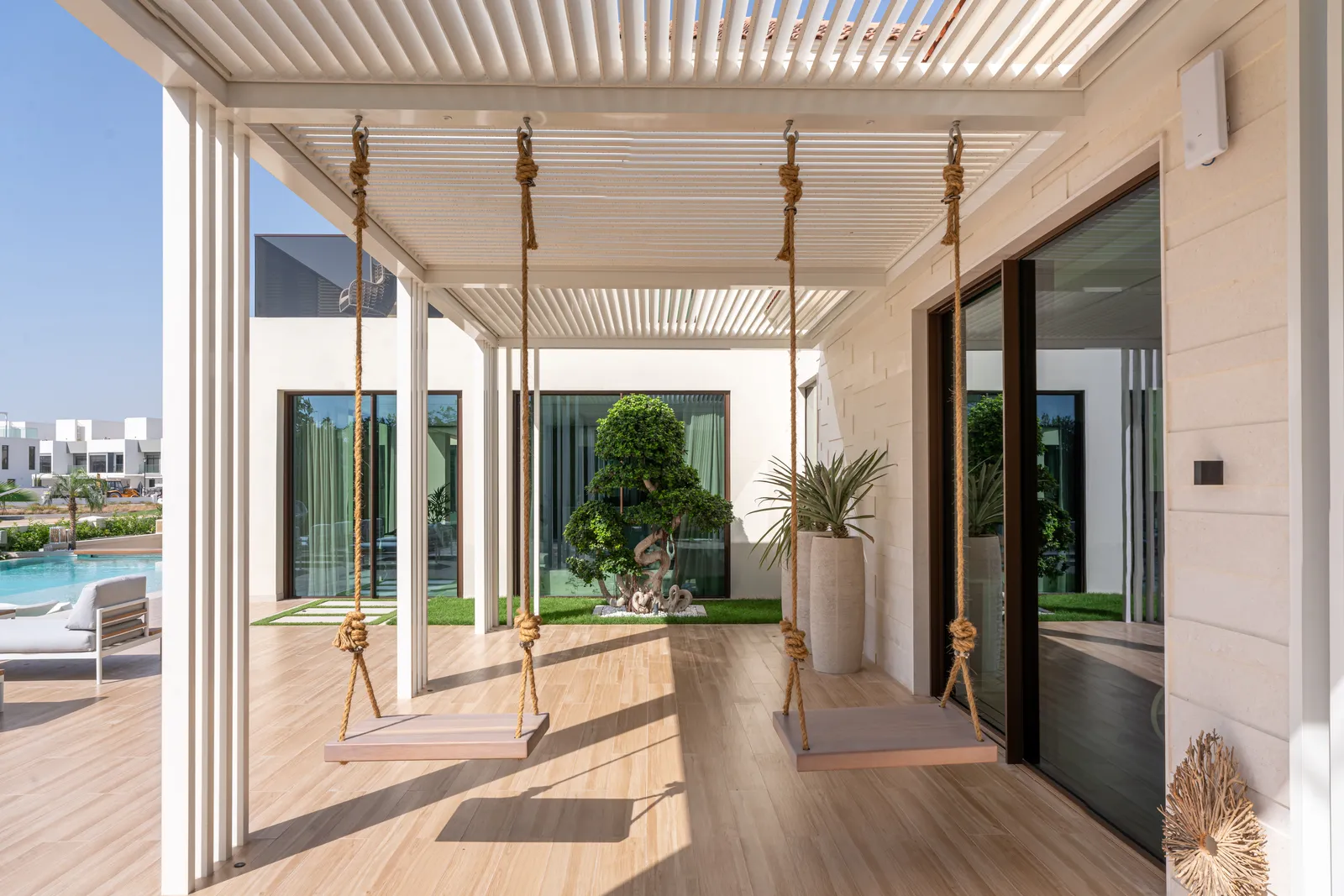 Hanging swing seat along the covered walkway