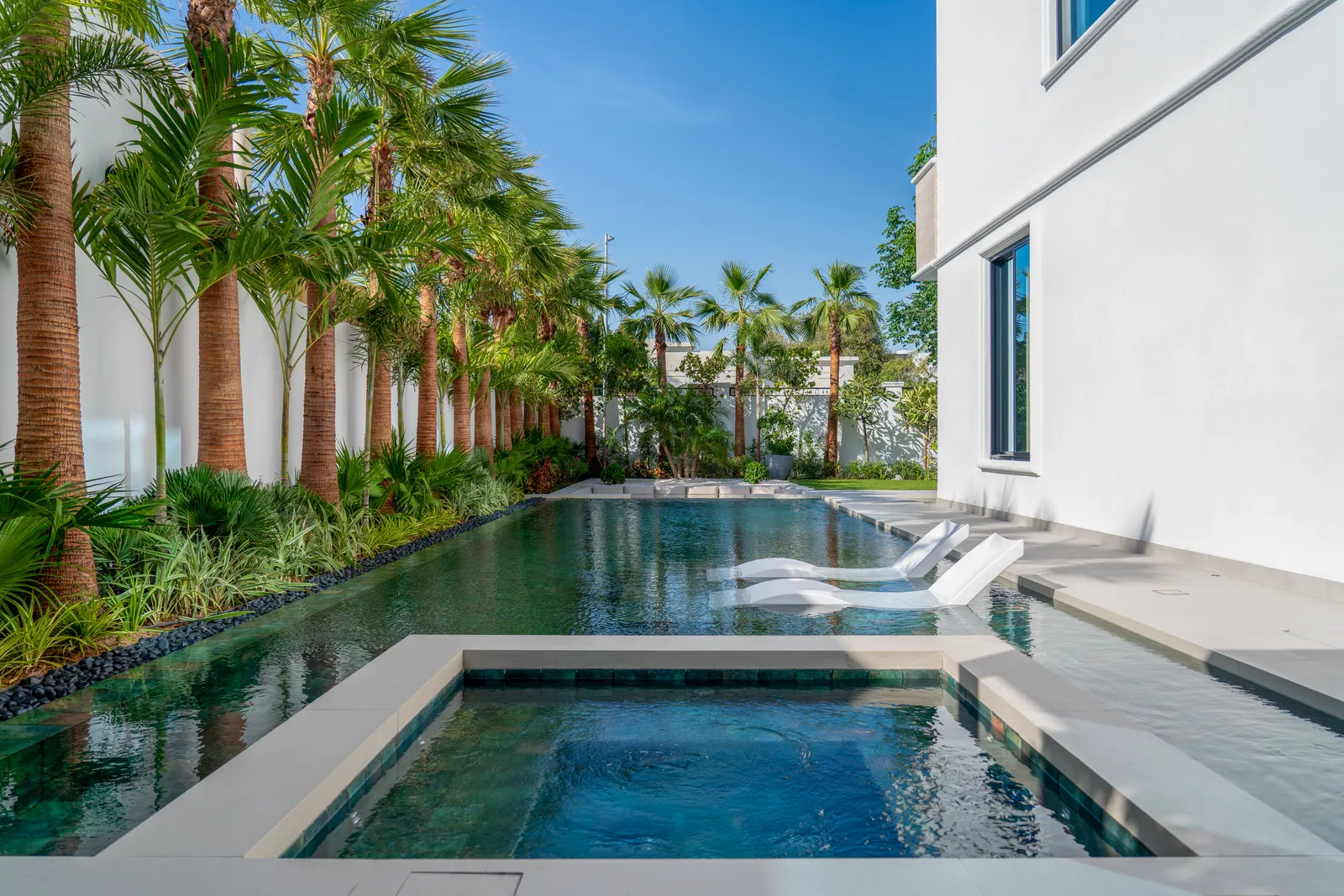 The lap pool running the length of the palm colonnade