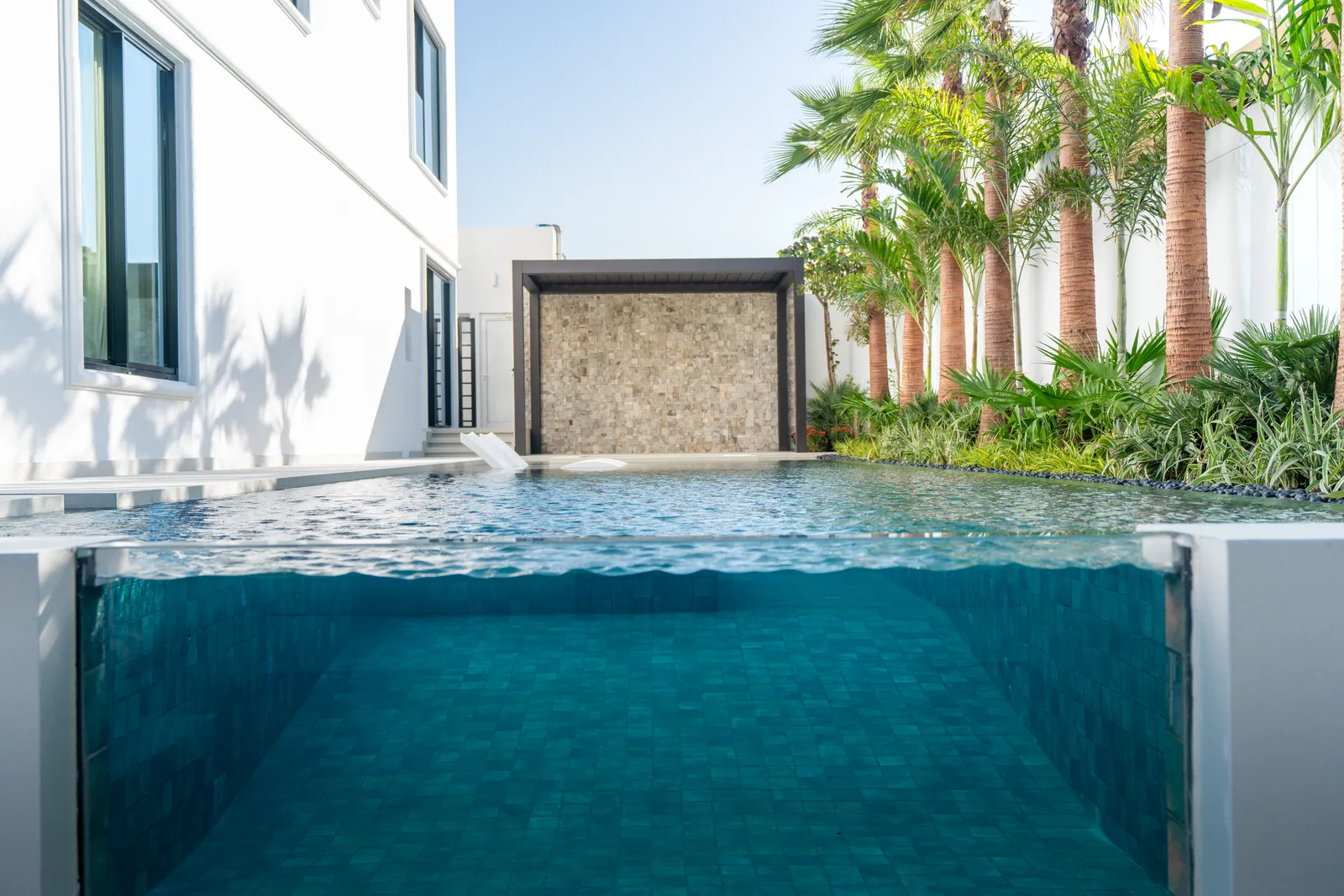Infinity edge meeting the stone water-feature wall