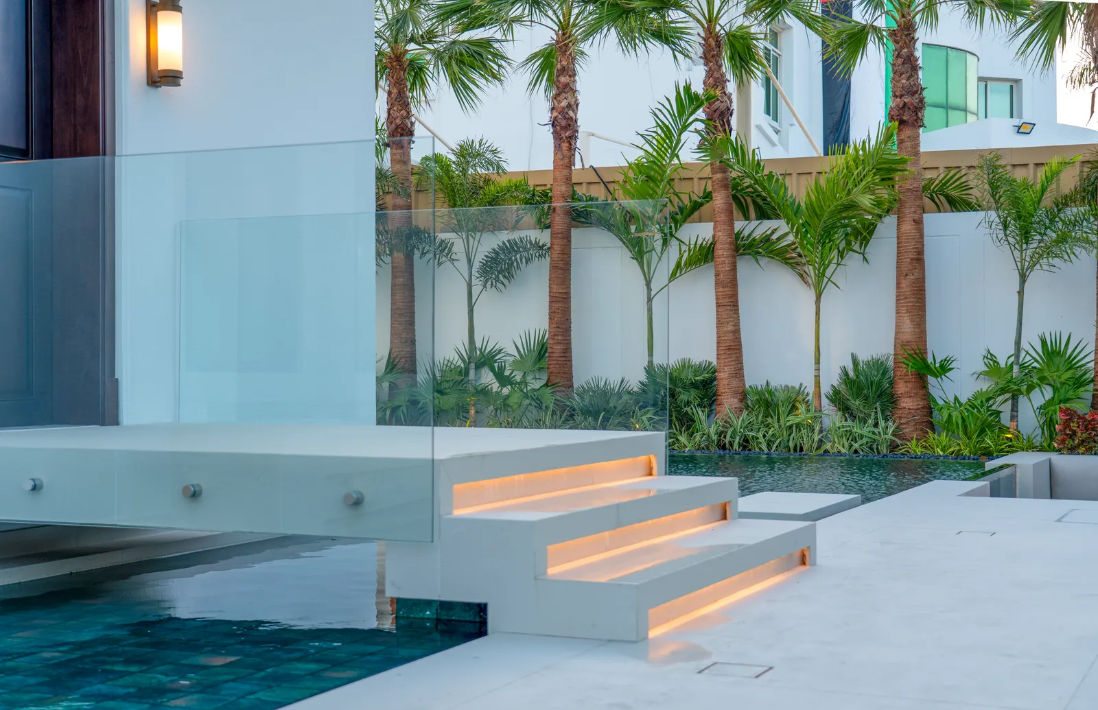 Floating steps lit from beneath as they enter the water