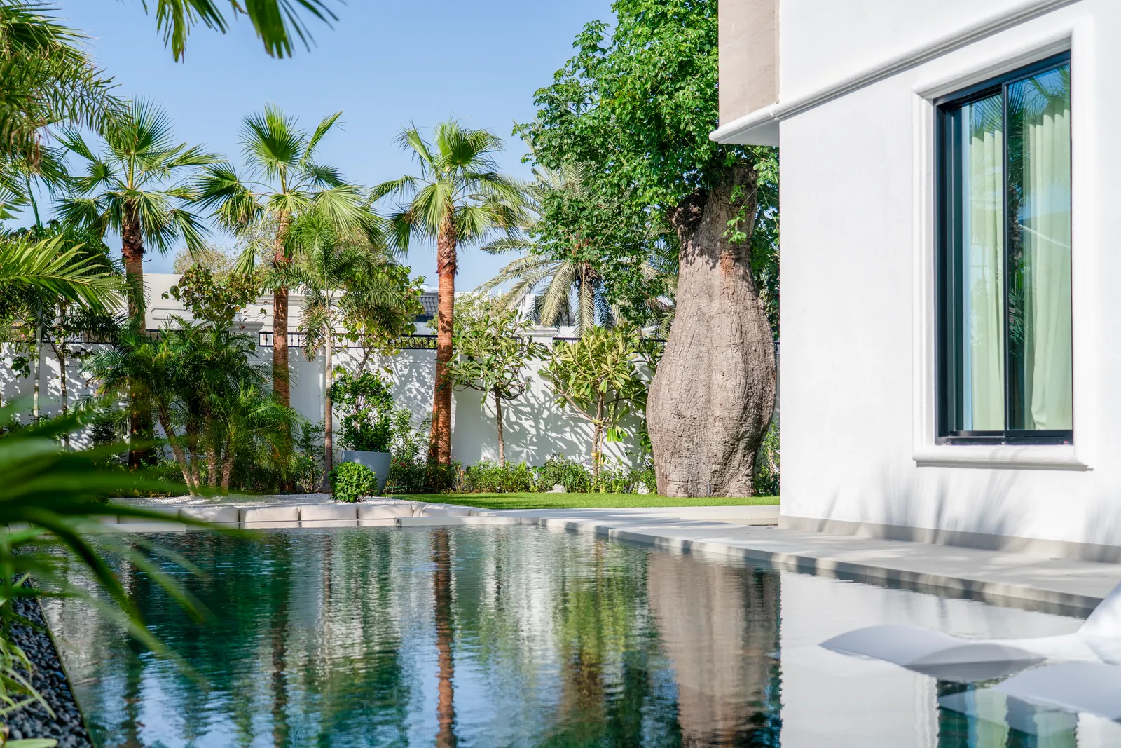 Villa 22 - Lap Pool & Palm Colonnade, landscape project by Luxland Landscaping